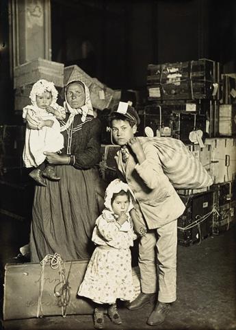 LEWIS W. HINE (1874-1940) Italian family in the baggage room, Ellis Island.